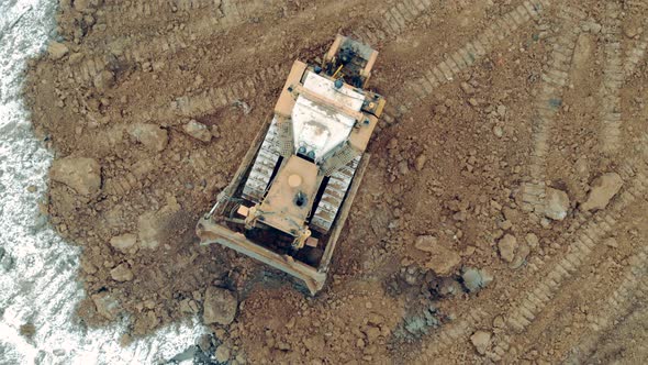 Top View of a Bulldozed Riding Along the Quarry Site