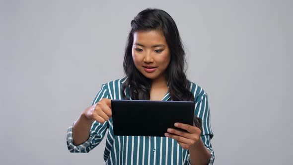 Happy Asian Woman Using Tablet Computer