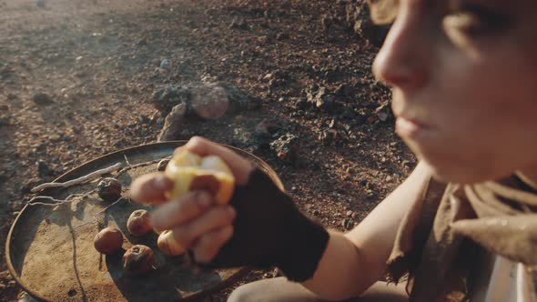 Woman in Eating Rotten Apples in Dystopian World