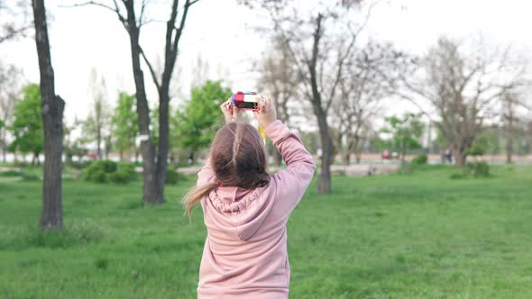 A child photographs nature with his first camera.