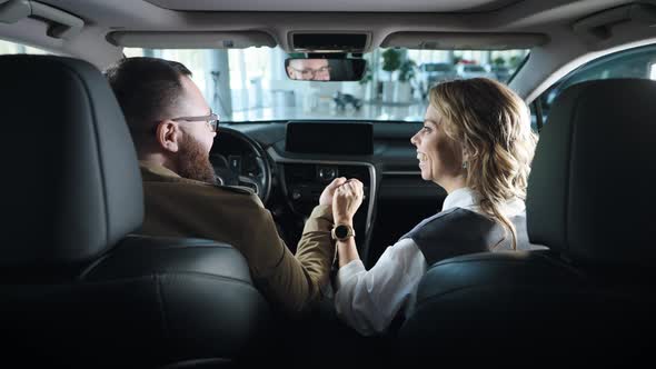 A Married Couple in the Salon of a New Car