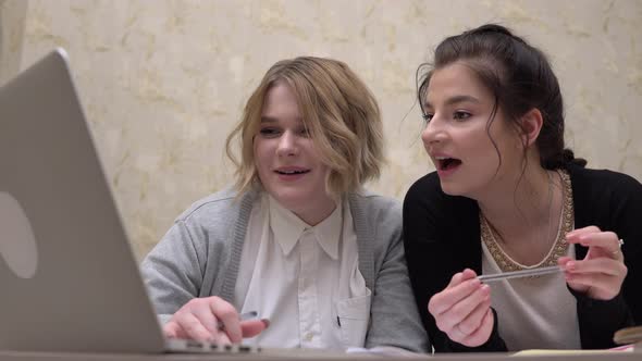 Laughing Woman Student Friends Looking at Laptop Screen Using Internet