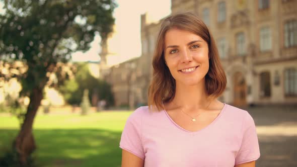 Close Up Young Woman Shows Thumb Up Near College