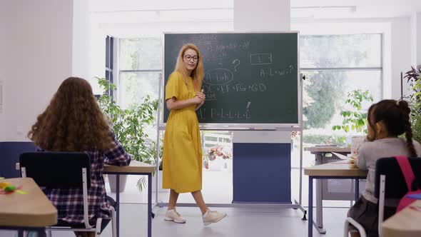 Female Teacher Explains Lesson to Children with Great Excitement and Interest