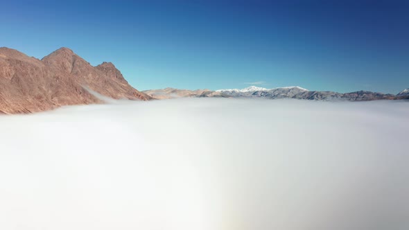 Beautiful Aerial View Over the Death Valley Covered By Fog Clouds at Sunrise