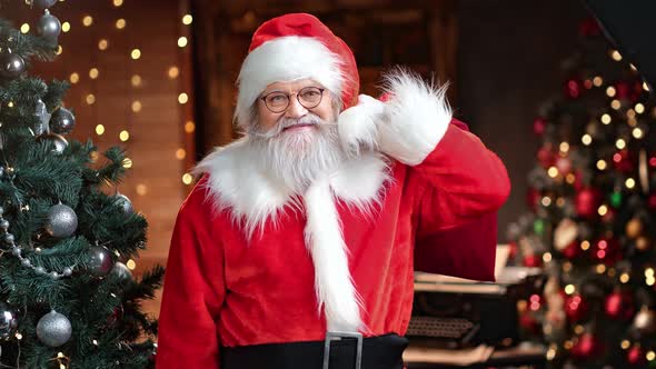 Elderly Man in Santa Claus Costume Smiling Carrying Sack Presents