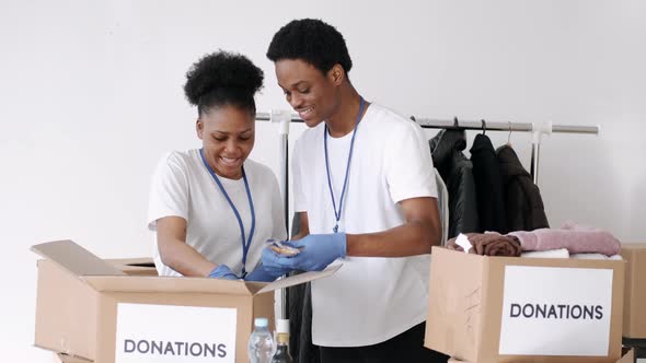 Volunteers Wearing Masks Sorting Clothes Donations During Pandemic