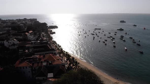 Aerial Waterfront and Seaport of Stone Town Anchored Boats in Ocean Zanzibar