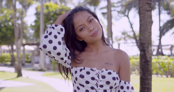 Charming Asian Woman in Dress with Open Shoulder Looking at Camera