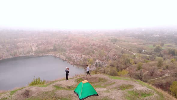 Aerial View of Happy Traveler Family Walk Near Tent Camp By Mountains Lake Enjoying Leisure and