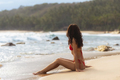 Contemplative Beach Getaway Young Woman in Swimsuit Gazing out at the Ocean - PhotoDune Item for Sale