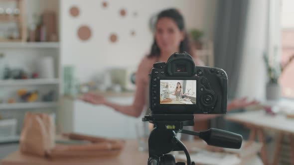 Woman Filming Cooking Vlog in Kitchen