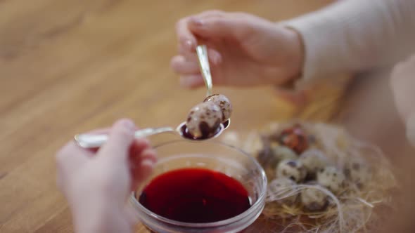 Unrecognizable People Holding Spoons with Dyed Quail Eggs