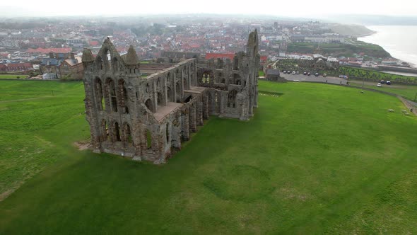 Whitby Abbey ruins and surrounding landscape, North Yorkshire in England. Aerial circling