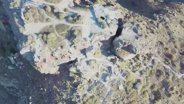 4k Aerial drone footage flying over Skaros rock Santorini Greece with caldera background