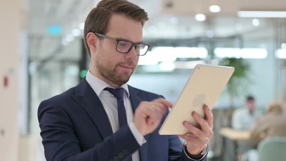 Businessman Celebrating Success on Tablet, Winning 