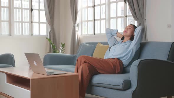 Asian Woman Sitting Sofa Use Laptop Computer And Relax In Home Living Room