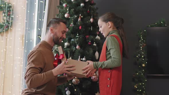 Father Giving Christmas Present to Little Girl