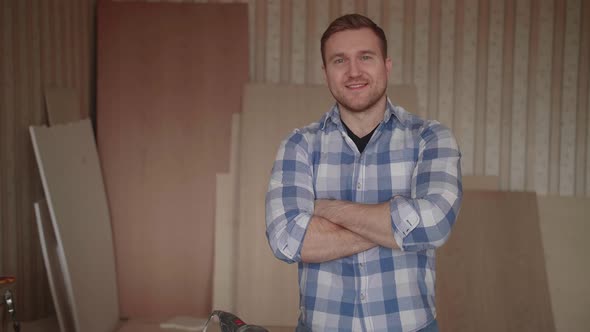 Portrait of a Young Carpenter Behind the Workplace