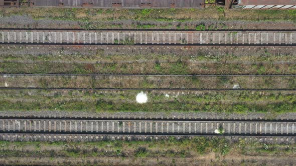 Flying Above Track for Freight or Passengers Trains at Industrial Railroad Station