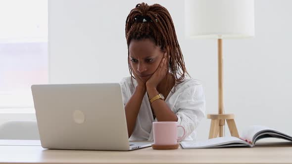 Sad African Woman Reading Receiving Bad Pandemic News on Laptop at Home Spbi