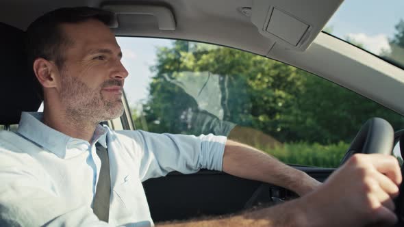 Caucasian man of middle age driving a car. Shot with RED helium camera in 8K.