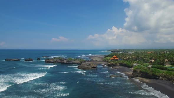 Ocean Coastline with Rocks, Grey Sand Beach and Local Village Aerial