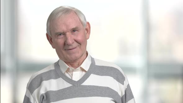 Senior Cheerful Man on Blurred Background