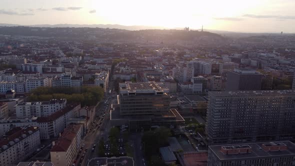 Aerial flying towards sunset over Lyon city, France