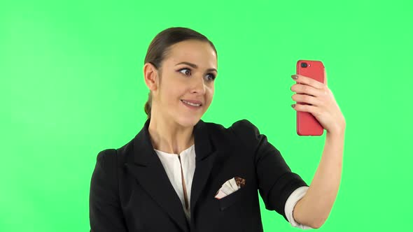 Girl Talking for Video Chat Using Mobile Phone. Green Screen