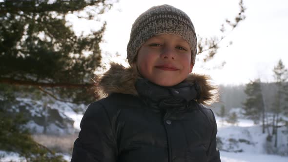 Young Boy Posing in Snowy Landscape