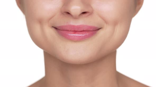 Macro Shot of Natural Lips with Pink Lipgloss of Beautiful Young Woman Having Clean Healthy Skin