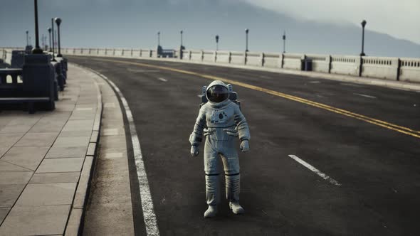 Astronaut in Space Suit on the Road Bridge alt