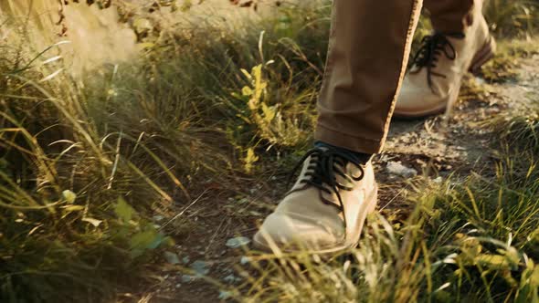 Close-up of a Hiker's Feet in Brown Boots. Walking in a Hike on a Steep Terrain on the Trail on the