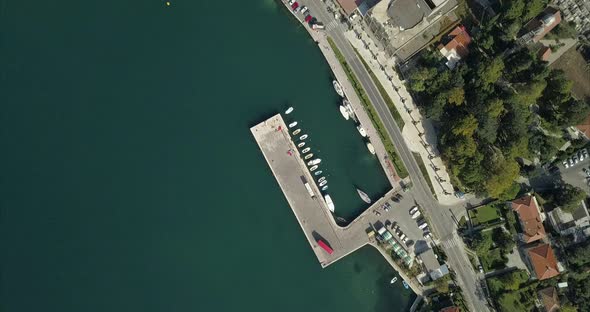 A small port on the bay of Kotor. Birds eye aerial view of the shoreline in Risan, Montenegro.