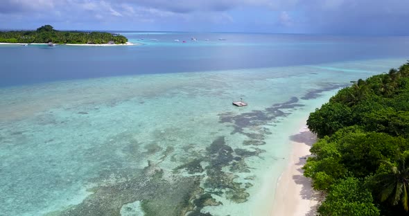 Beautiful fly over copy space shot of a white sand paradise beach and blue water background in colou