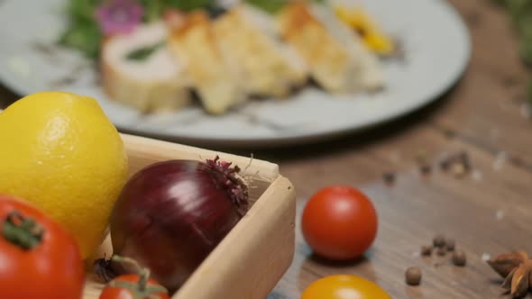 Table with Vegetables Spices and Chicken Roll