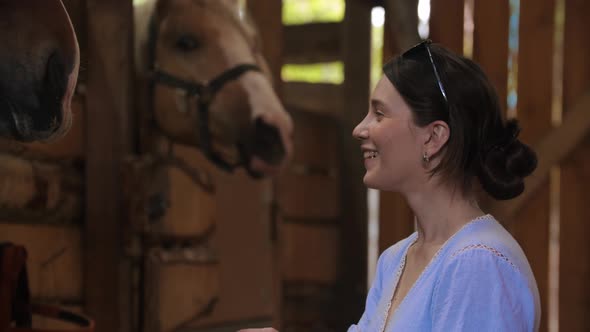 Smiling Happy Woman Feeding Horse an Apple in Paddock