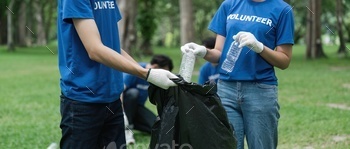 Team volunteers collecting garbage in public park. Environmental protection Concept
