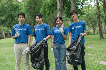 Team volunteers collecting garbage in public park. Environmental protection Concept