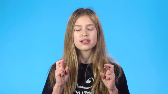 Girl Making a Wish with Crossed Fingers, Closed Eyes, Dancing