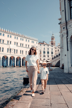 cal adventure, exploring the picturesque canals of Venice. Their bond and joy radiate as they navigate the enchanting waterways, creating beautiful memories