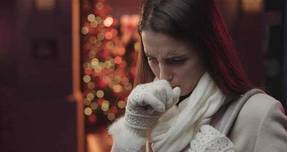 Young woman coughing.