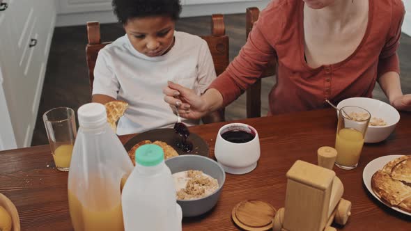 Mom Putting Jam for Sons Waffles