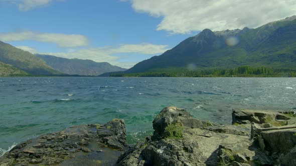 Turquoise rough waters on a  windy day. Emerald Lake Epuyen Patagonia Argentina. Timelapse Slider sl