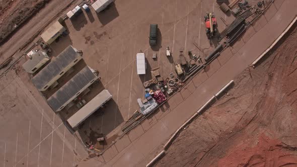 Aerial view flying over construction worksite at lake