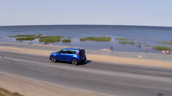 Blue Car Drive on the Road Near the Bay