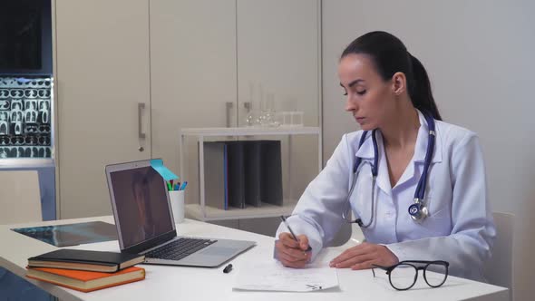 Woman Doctor Talking with Husband Using App on Computer