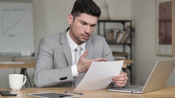 Frustrated Businessman Tearing Contract Papers