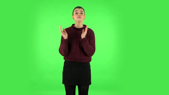 Girl Claps Her Hands Indifferently. Green Screen